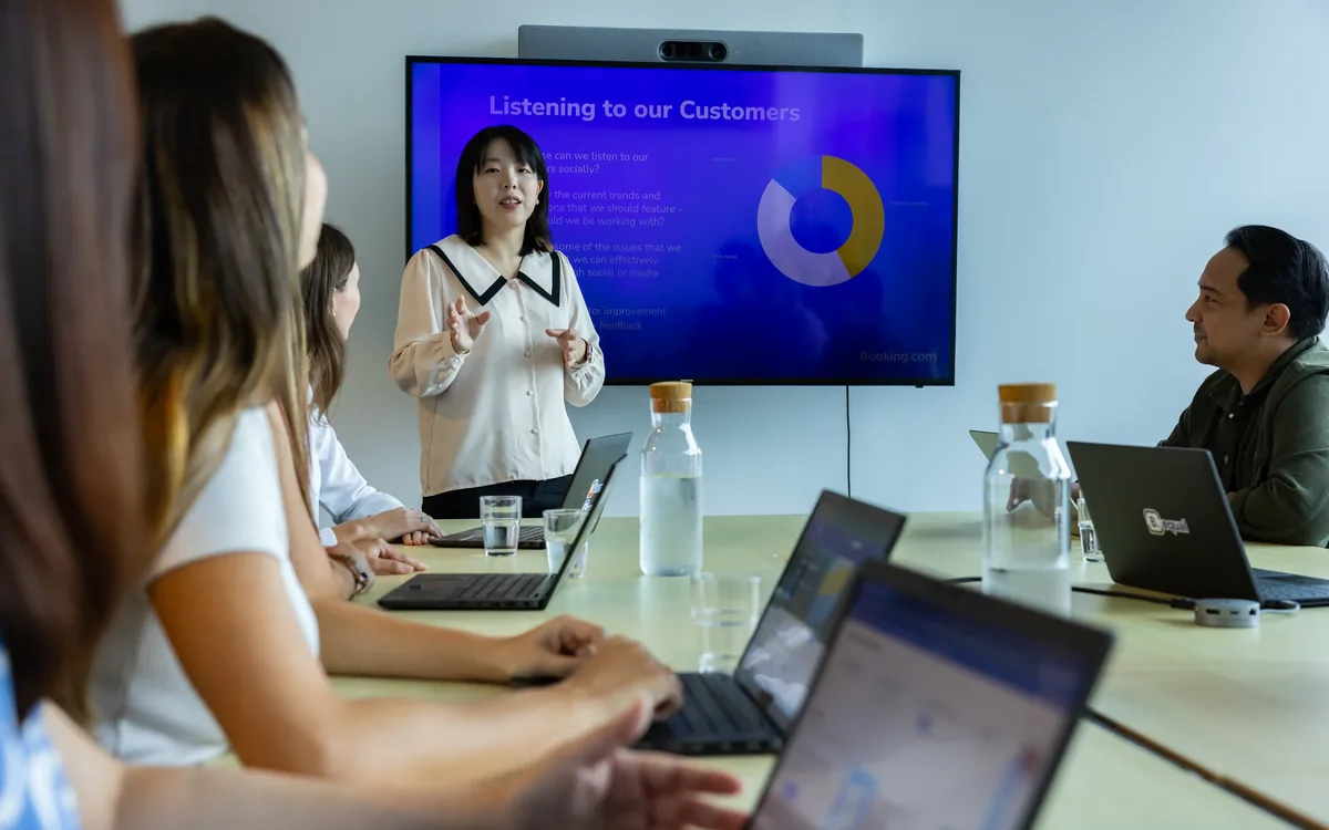 Po Chun presenting a Listening to our Customers session to a team at Booking.com